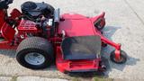 A red 2014 Ferris Zero-Turn mower with a large cutting deck and four wheels visible one of which has a flat tire