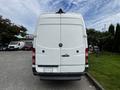 A white 2016 Mercedes-Benz Sprinter van viewed from the rear with its doors closed and the brand logo visible on the center of the door