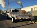 A 2014 RAM 5500 with a flatbed and metal side rails positioned for work