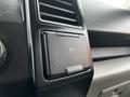 Close-up of a 2016 Ford F-150 dashboard featuring a 12V power outlet and ventilation vents