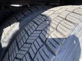 Close-up view of two heavily treaded tires from a 2014 International 7400 showcasing detailed tread design and wear patterns