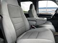 Interior view of a 2007 Ford F-550 showing two gray upholstered front seats with a center console in between