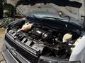 A 2017 Chevrolet Express with its hood open showing the engine compartment featuring the engine and various components such as coolant reservoir and air intake
