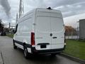 A 2021 Mercedes-Benz Sprinter van in white with a rear view showcasing the taillights and cargo area design