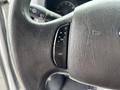 Close-up of the steering wheel controls of a 2014 Ford E-350 showing buttons labeled ON and OFF