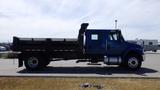 A blue 2012 International DuraStar 4300 flatbed truck viewed from the side with a flatbed cargo area and a single cab