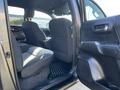 Interior view of a 2021 Toyota Tacoma showing the rear seats and door panel with a black finish and fabric upholstery