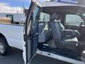 A 2013 Ford F-250 SD truck with an open driver's side door showing a gray interior with two front seats and storage space in the cabin