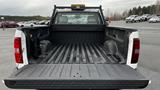 A 2013 Chevrolet Silverado 1500 with an open truck bed showing a black liner and no visible cargo inside