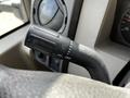 Close-up of a turn signal lever from a 2008 Ford F-550 with markings for various functions including off and hazard lights
