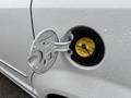 Close-up of a white 2017 Dodge Grand Caravan's fuel cap with a yellow fuel filler indicator visible inside