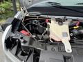 Engine compartment of a 2020 Chevrolet Express showing the battery coolant reservoir and various components with visible hoses and wires
