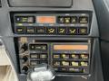 Dashboard controls of a 1992 Chevrolet Corvette featuring buttons for temperature, auto settings, mirror adjustments, and audio controls