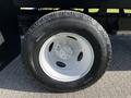 A close-up of a black tire with a white rim from a 2019 Ford Econoline van