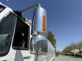 A close-up of the side mirror of a 2009 International 7500 truck showing a chrome finish and an orange light indicator