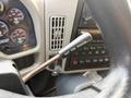 A close-up of the gear shift lever inside a 2016 International 7400 truck with a label stating NOT FOR PARKING