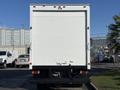 A white 2014 Hino 195 box truck viewed from the rear with a smooth surface and a hitch for towing