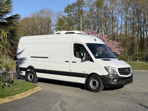 A white 2016 Mercedes-Benz Sprinter van with a high roof and black accents parked at an angle