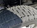 Close-up view of a worn tire tread on a 2021 Ford F-550 showcasing the deep patterns and grooves on the tire surface