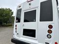 A white 2020 Chevrolet Express with a rear door and handicap accessibility symbol visible