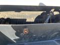 Close-up view of a 2016 Ford F-250 SD truck bed with a visible rusted bolt on the edge of the bed liner