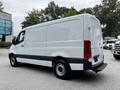 A white 2020 Mercedes-Benz Sprinter van viewed from the rear and side angles showcasing its sleek design and cargo space