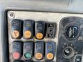 A control panel with multiple buttons and switches labeled for functions like power and operation on a 2007 Komatsu WB156PS-5