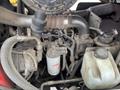 Close-up of the engine components of a 2012 Toro Groundsmaster 5910 showing pipes filters and reservoirs