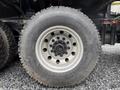 A close-up of a Yokohama tire on a 2018 Kenworth T800 with a metallic rim featuring multiple lug nut holes and a rugged tread pattern