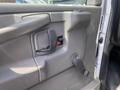 Interior door panel of a 2009 Chevrolet Express featuring a handle a power lock button and a manual window crank