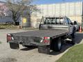 A 2020 Ford F-550 with a flatbed design featuring wooden planks and a metal frame visible in the foreground