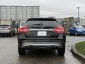 A 2016 Mercedes-Benz GLA-250 in black viewed from the rear with dual exhausts and a visible license plate area