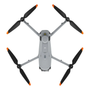Aerial drone with four black propellers and orange tips featuring a sleek gray body and various sensors on top