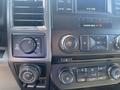 Interior dashboard controls of a 2017 Ford F-150 featuring dials buttons and a digital display for audio and vehicle settings