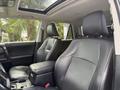 Interior view of a 2021 Toyota 4Runner featuring black leather seats and a center console with storage