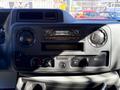 Dashboard of a 2021 Ford E-450 featuring control knobs for climate and audio systems and a display panel with a digital clock