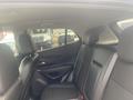 Interior view of a 2018 Buick Encore showcasing the rear seating area with black leather upholstery and door panel details