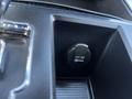 A close-up of a 12V DC power outlet in a 2011 RAM 1500 vehicle's interior