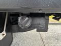 Close-up of a 2017 Ford F-550 fuel tank cap assembly mounted on the vehicle's frame with a black finish and a metal latch mechanism