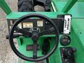 Close-up view of the control panel of a 2014 JLG 10054 featuring a steering wheel, control buttons, gauges, and safety information labels
