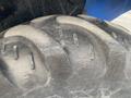Close-up of a heavily treaded tire from a 2016 New Holland T475 tractor showing dirt accumulation and wear on the surface