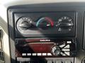 Dashboard controls of a 2008 International 7500 featuring climate control knobs and a Delphi radio system with tuning and volume buttons