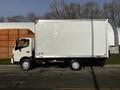 A 2015 Hino 195 box truck with a white exterior and a large empty cargo area on the back