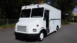 White 2004 Freightliner MT45 box truck with an open side door and amber light on top