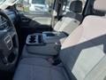 Interior of a 2018 GMC Sierra 1500 showing two front seats with a center console and cup holders between them