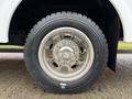 A close-up of a chrome wheel on a 2011 Ford F-550 showcasing a rugged tire with deep treads and a shiny rim