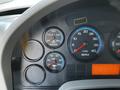 Dashboard of a 2011 International 7300 showing gauges for water temperature oil pressure and RPM with an orange display panel