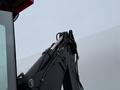 A 2011 John Deere 310SJ 4x4 Wheel Loader Extended Hoe 4 in 1 with a hydraulic arm and attachment visible in the foreground