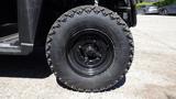 Close-up of a black tire on a 2016 Polaris Ranger 570 Crew showcasing rugged tread and alloy wheel design