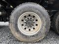 Close-up of a dirty tire from a 2018 Kenworth T800 with visible tread pattern and silver wheel rim